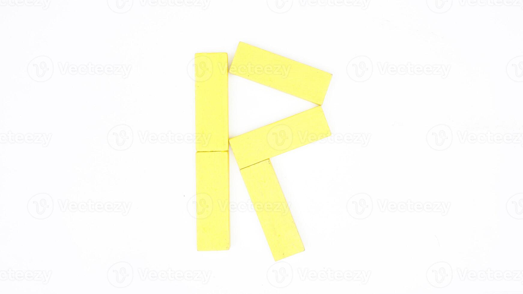 Letter R from yellow color wood block isolated on white background photo