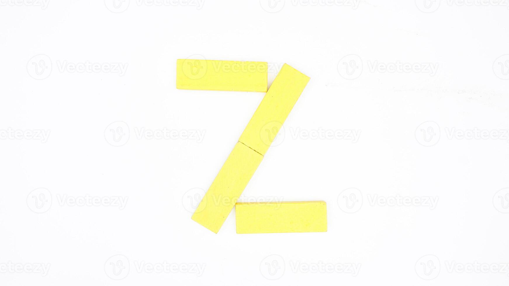 Letter Z from yellow color wood block isolated on white background photo