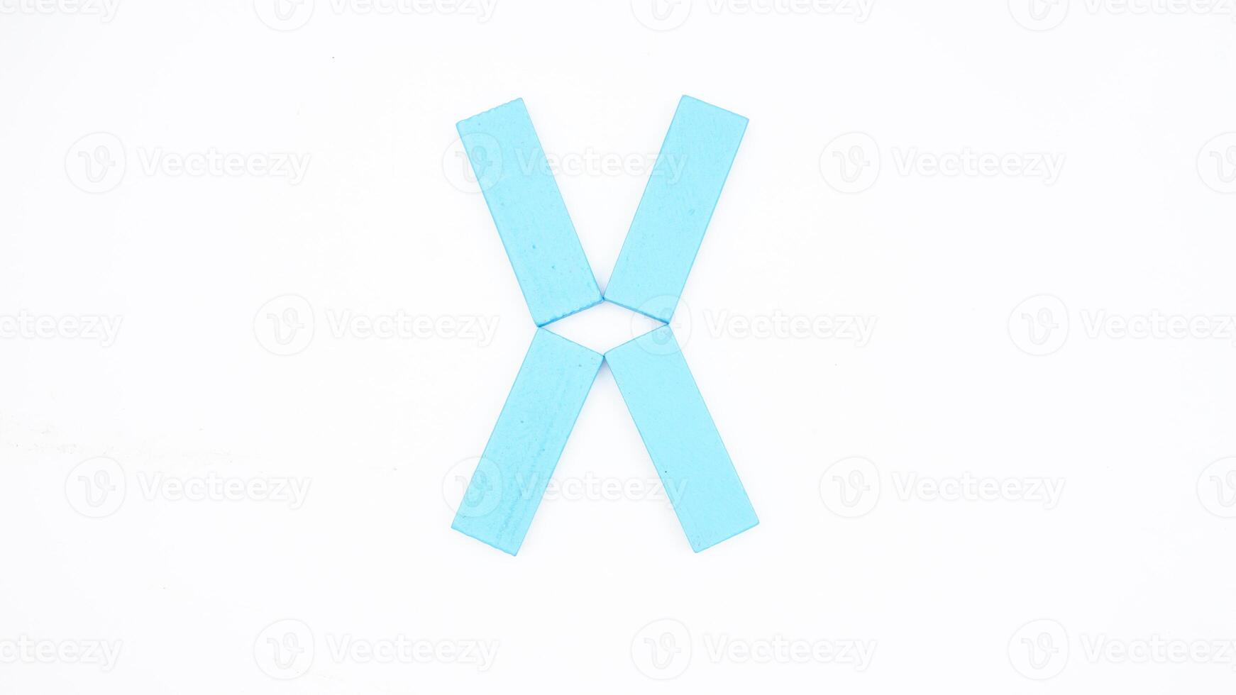 Letter X from blue color wood block isolated on white background photo