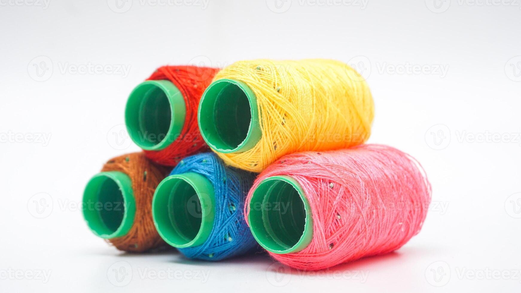 Sewing thread spool with various colors isolated on white background photo