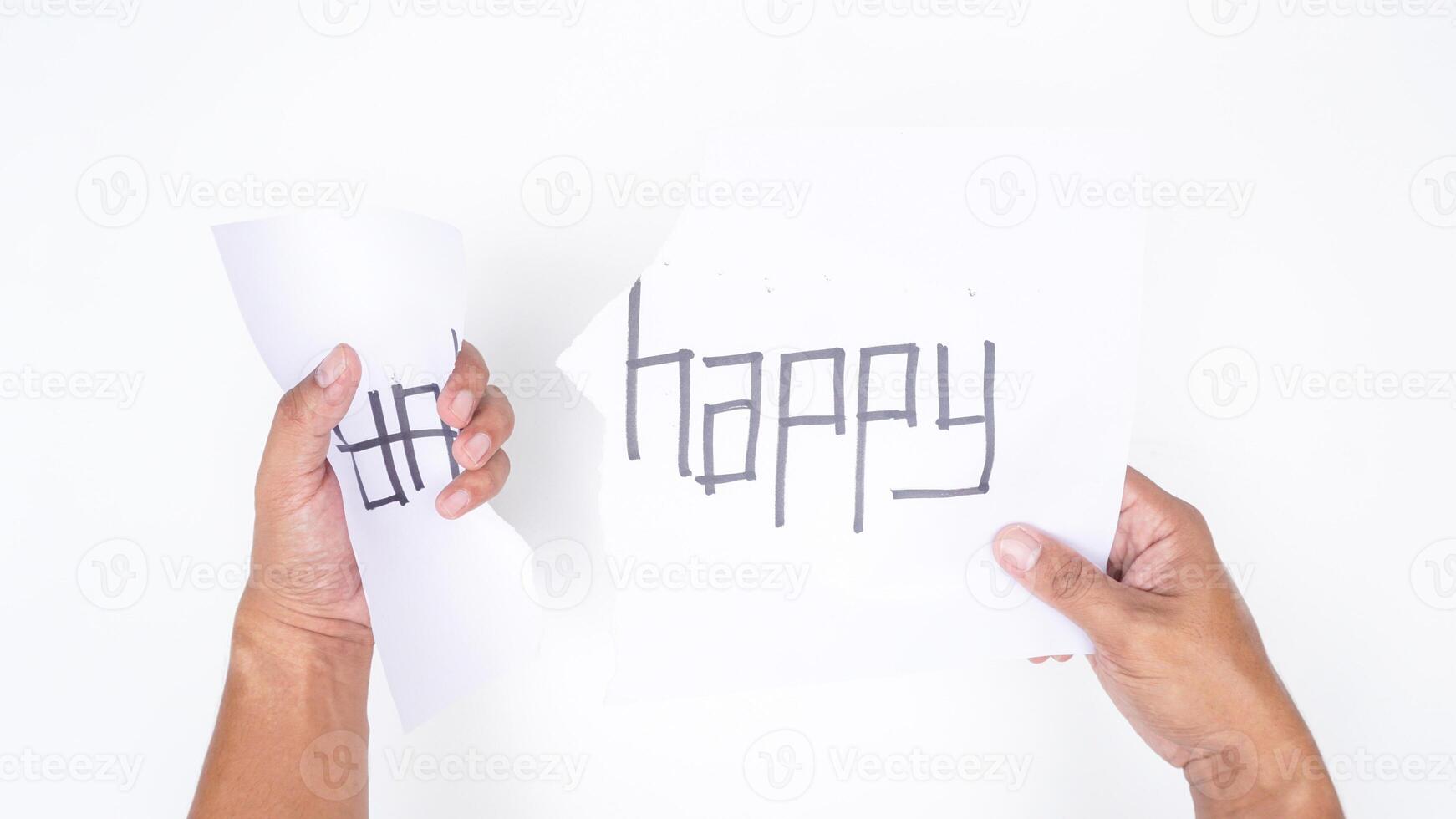 Close up of hands tearing letters UN from word UNHAPPY to get HAPPY isolated on white background photo