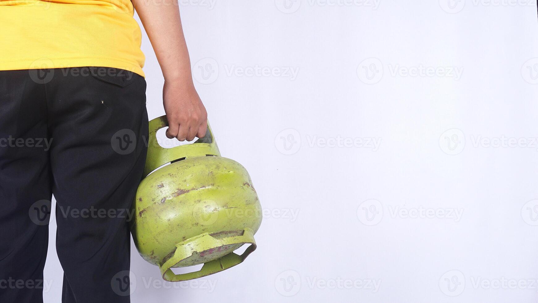 Rear view of Asian man holding Indonesia 3kg LPG gas cylinder isolated on white background photo