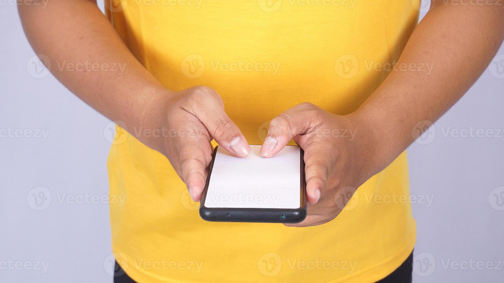 Close up of man holding mobile phone with blank screen mock up isolated on white background photo