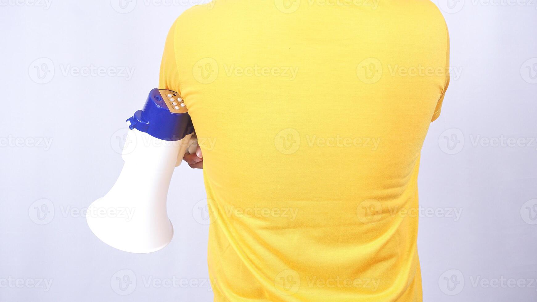 Rear view of man holding megaphone isolated on white background photo