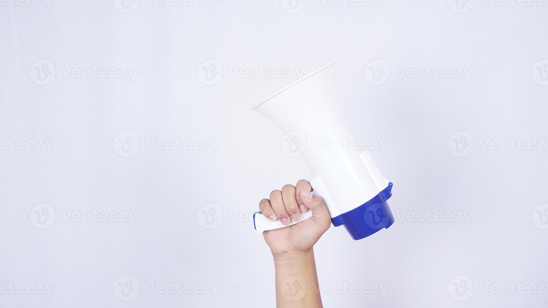 Hand holding megaphone isolated on white background photo