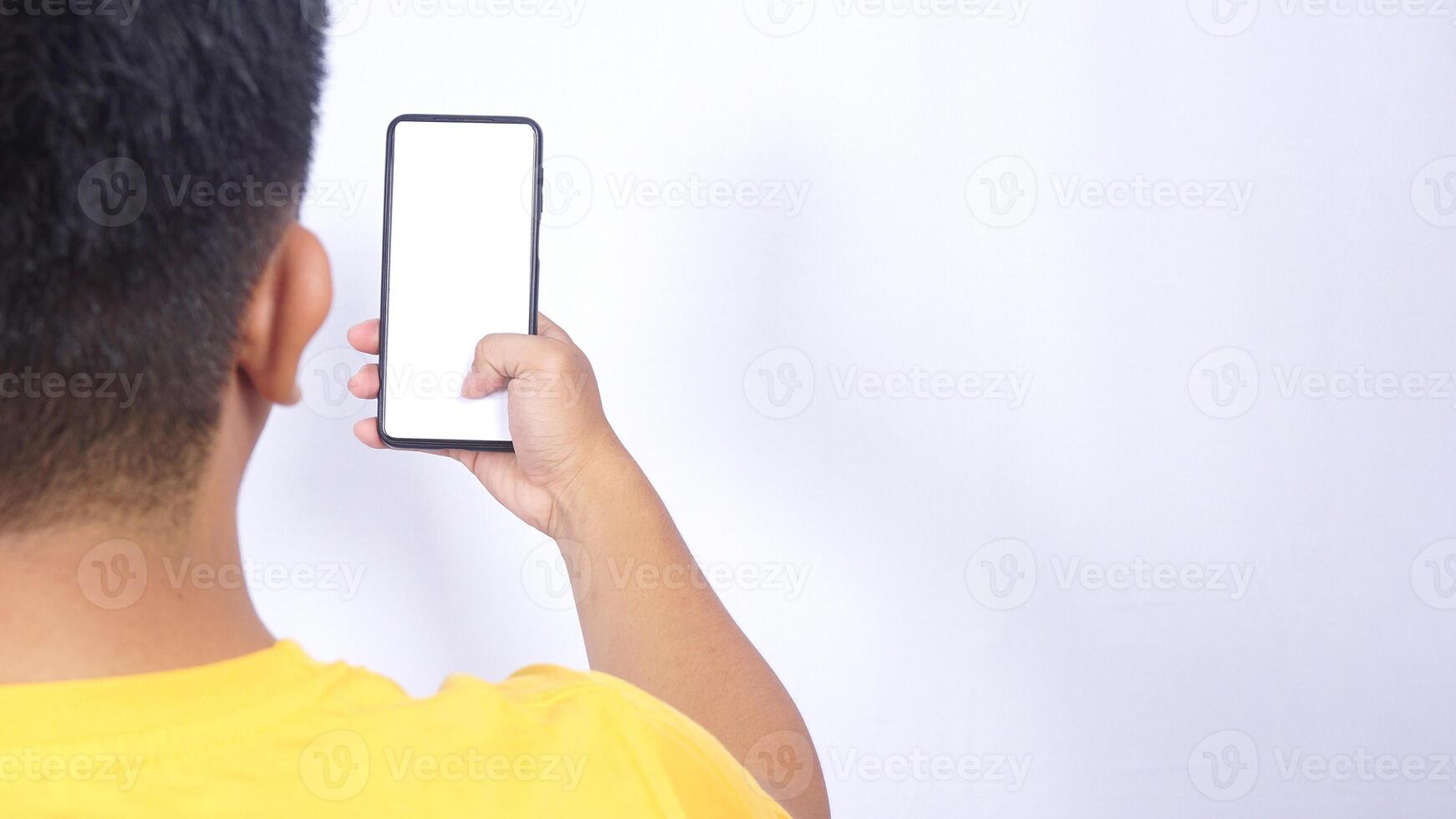Rear view of man holding mobile phone isolated on white background photo