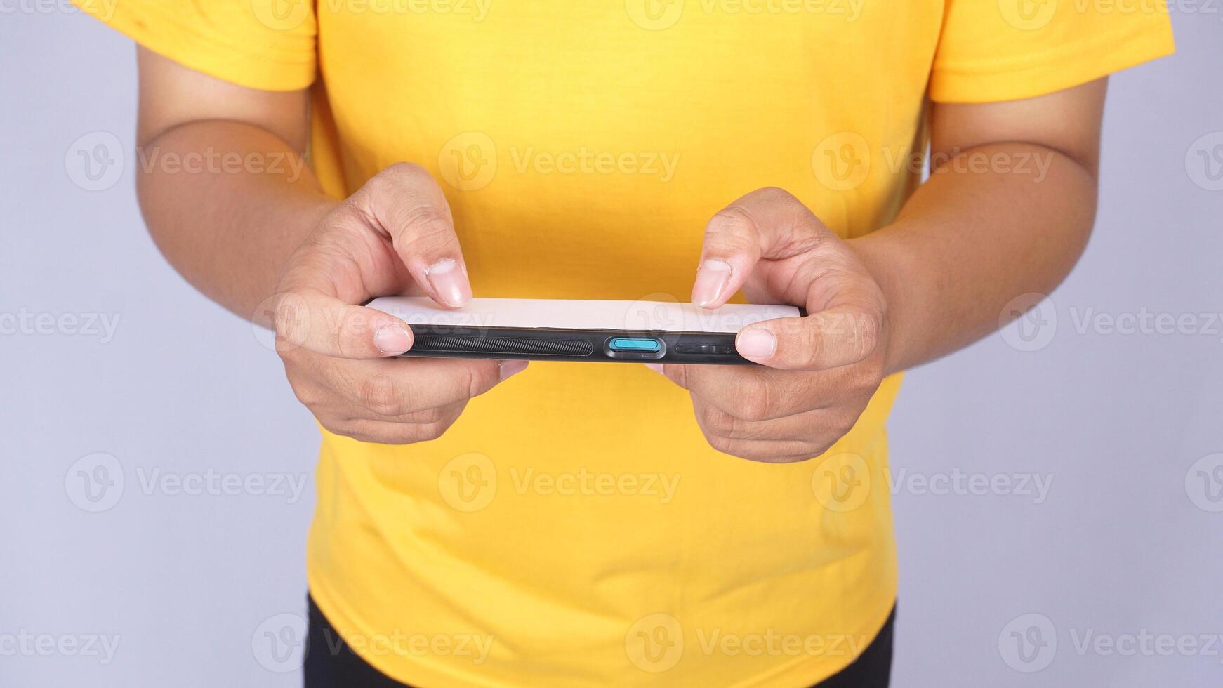 Top view of Asian man playing mobile phone in horizontal position isolated on white background photo