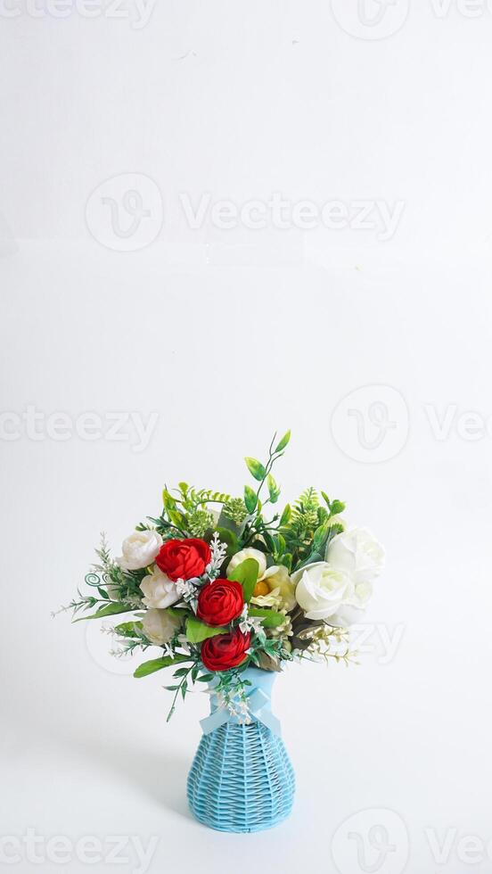Artificial flowers arrangement in vase isolated on white background photo