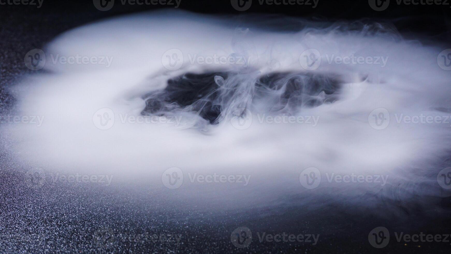 Dense abstract fog isolated on black background photo