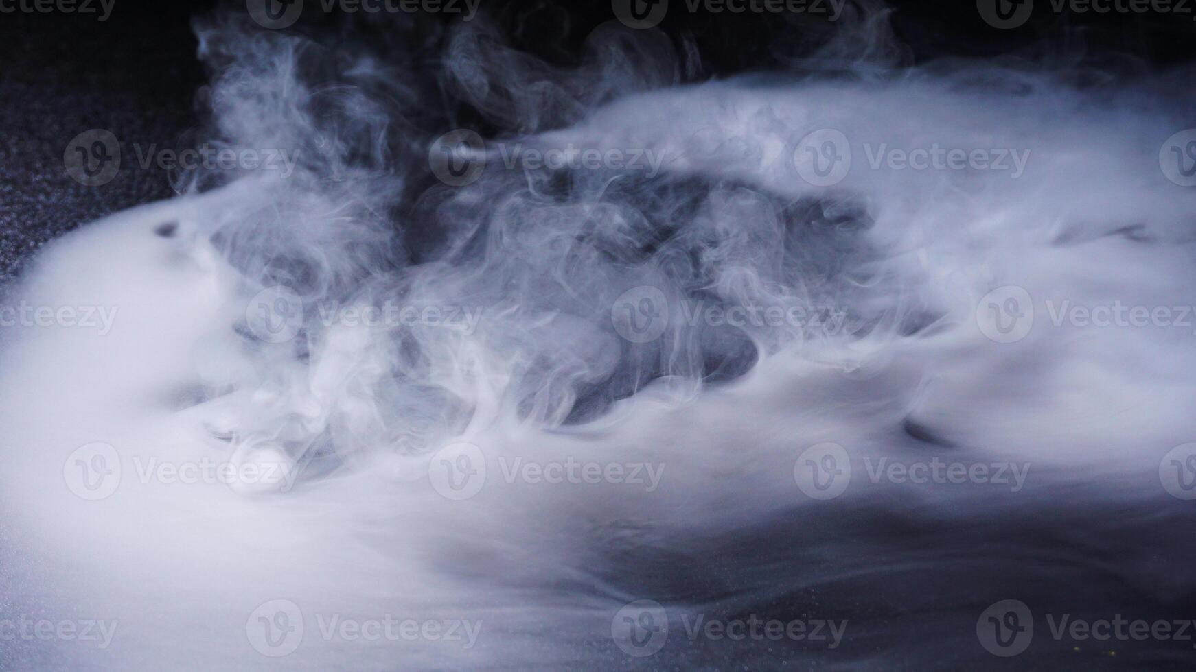 Dense white smoke isolated on black background studio photo