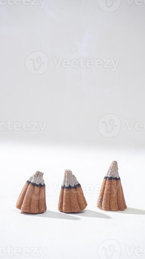 Three burned incense cones for aromatherapy isolated white background photo