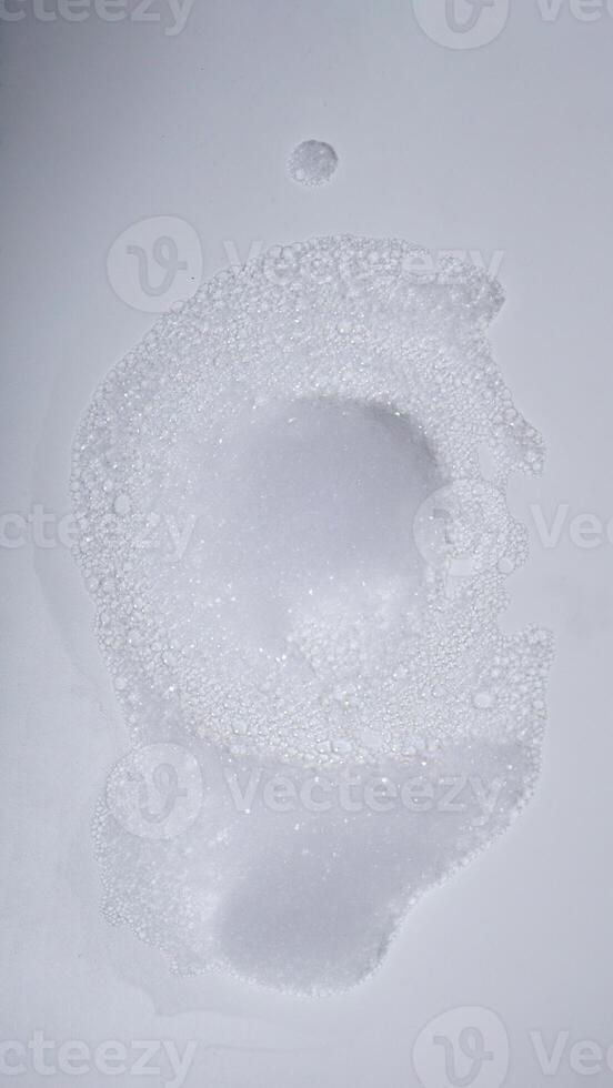 White foam with bubbles isolated on white background photo