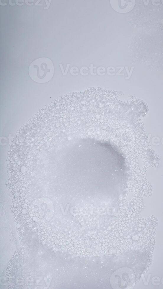 White foam with bubbles from soap isolated on white background photo