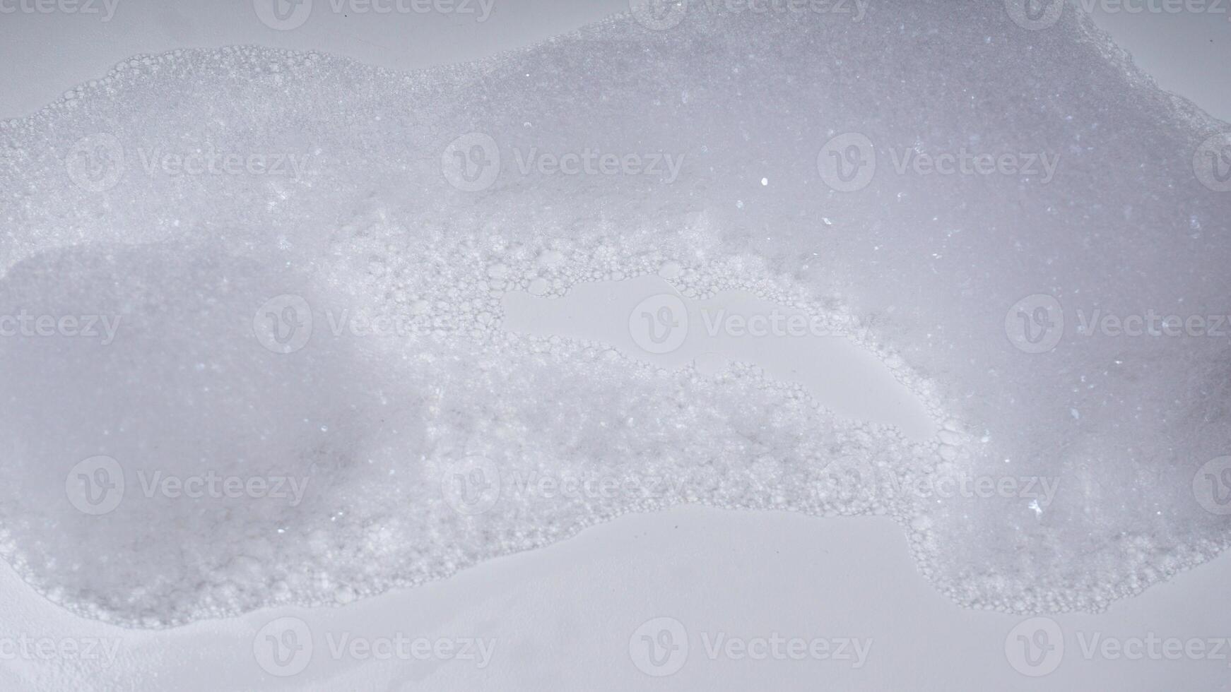 Soap foam with bubbles isolated on white background photo