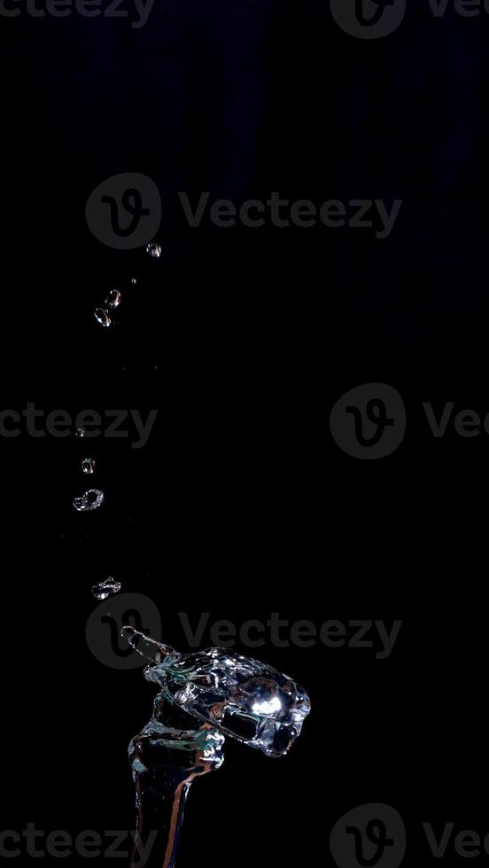 Splash and drops of water isolated on black background photo