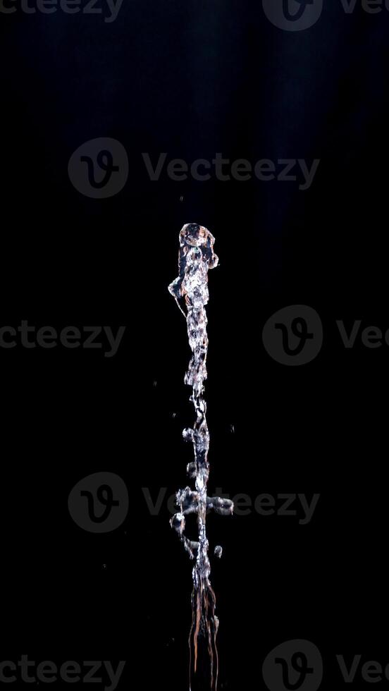 Abstract shape of water splash isolated on black background photo