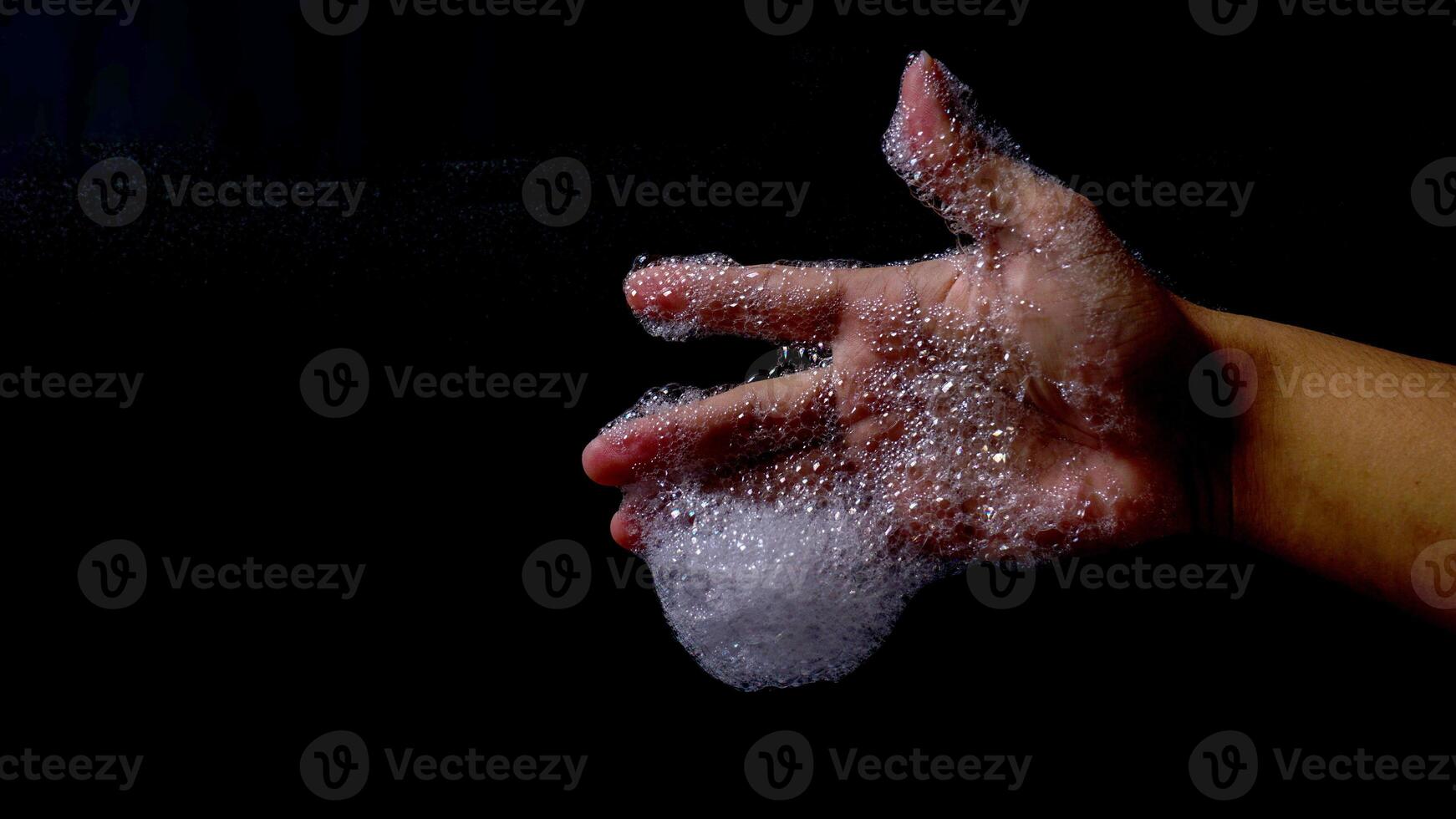 Foam soap with bubble in man hand isolated on black background photo
