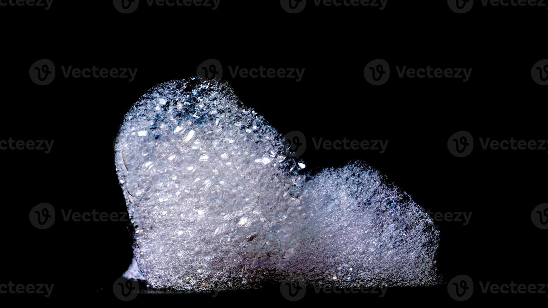 Abstract bubbles foam texture isolated on black background photo