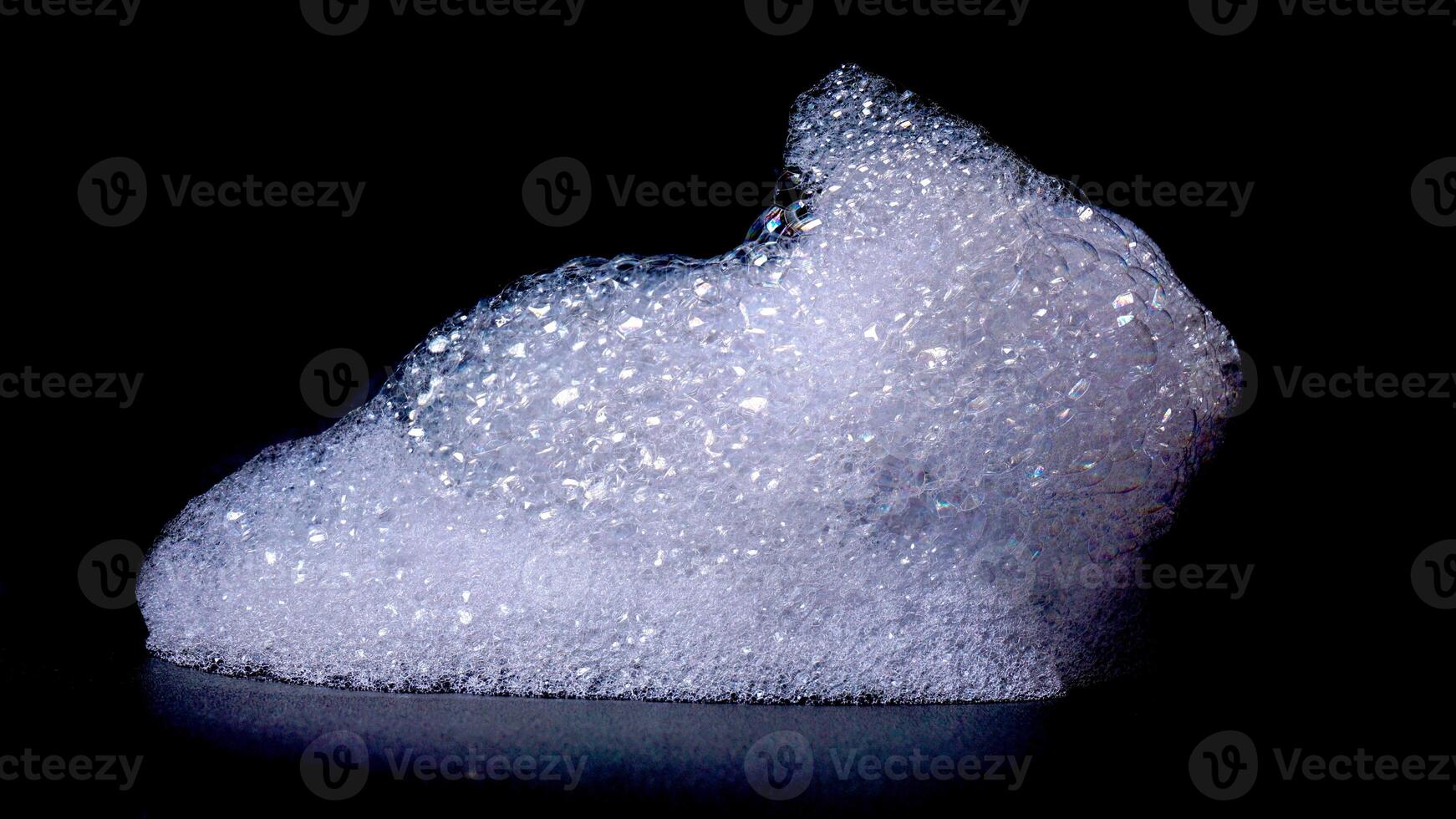 Close up of bubbles foam isolated on black background photo