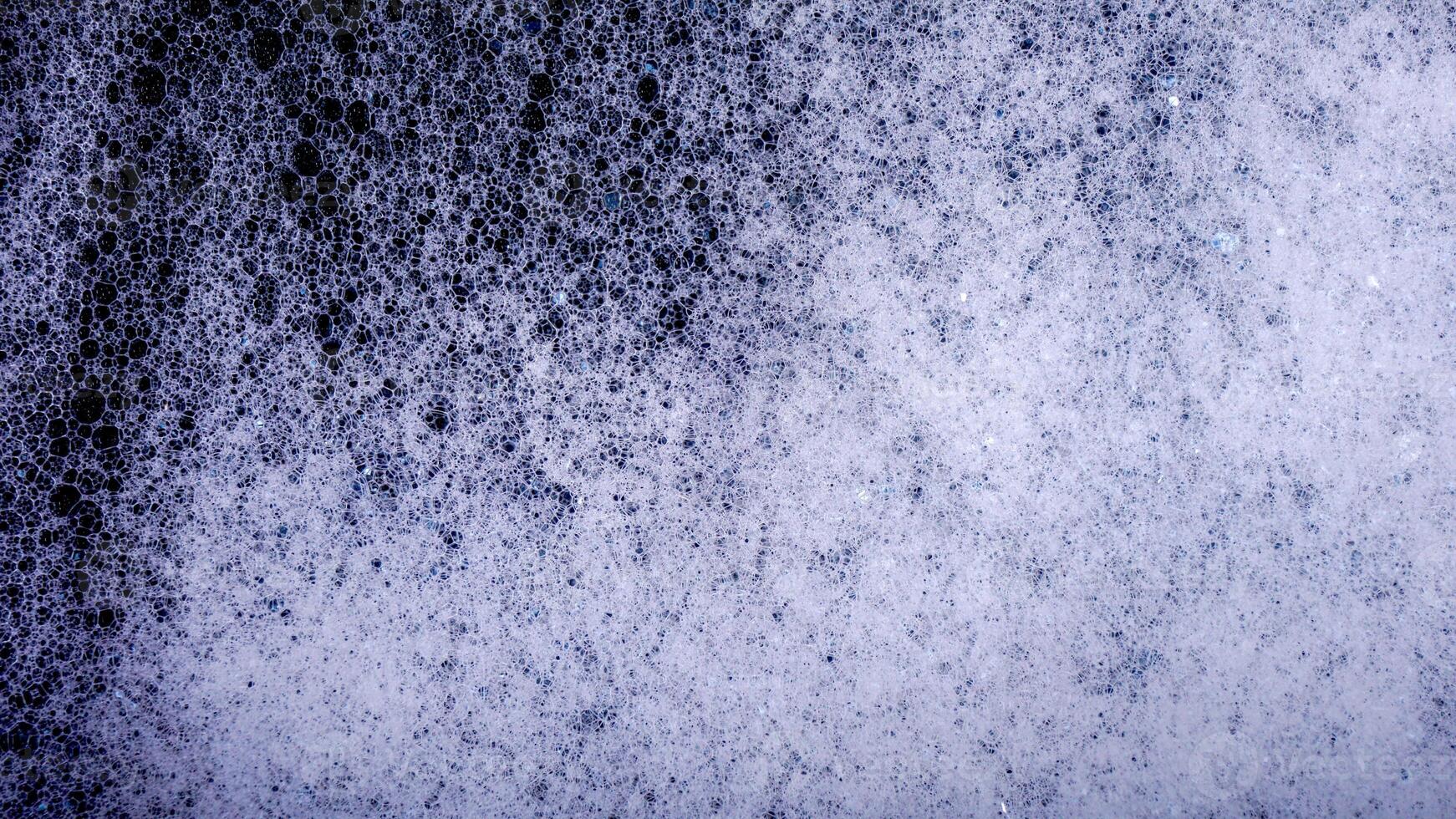 Abstract white bubbles foam texture isolated on black background photo