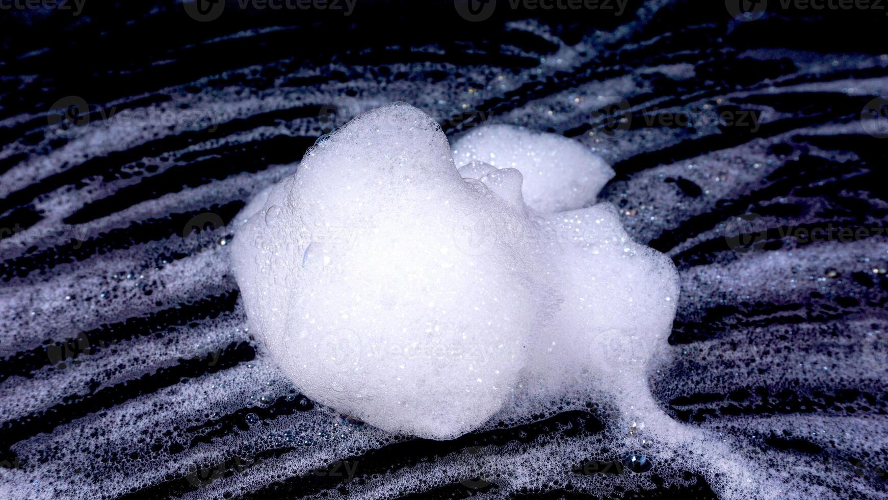 White foam isolated on black background photo