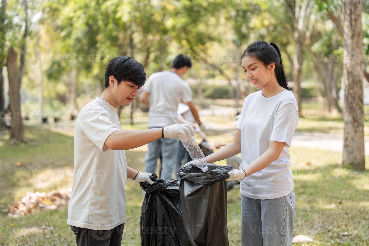 Volunteers engaging in a community cleanup, collecting trash in a park setting. photo