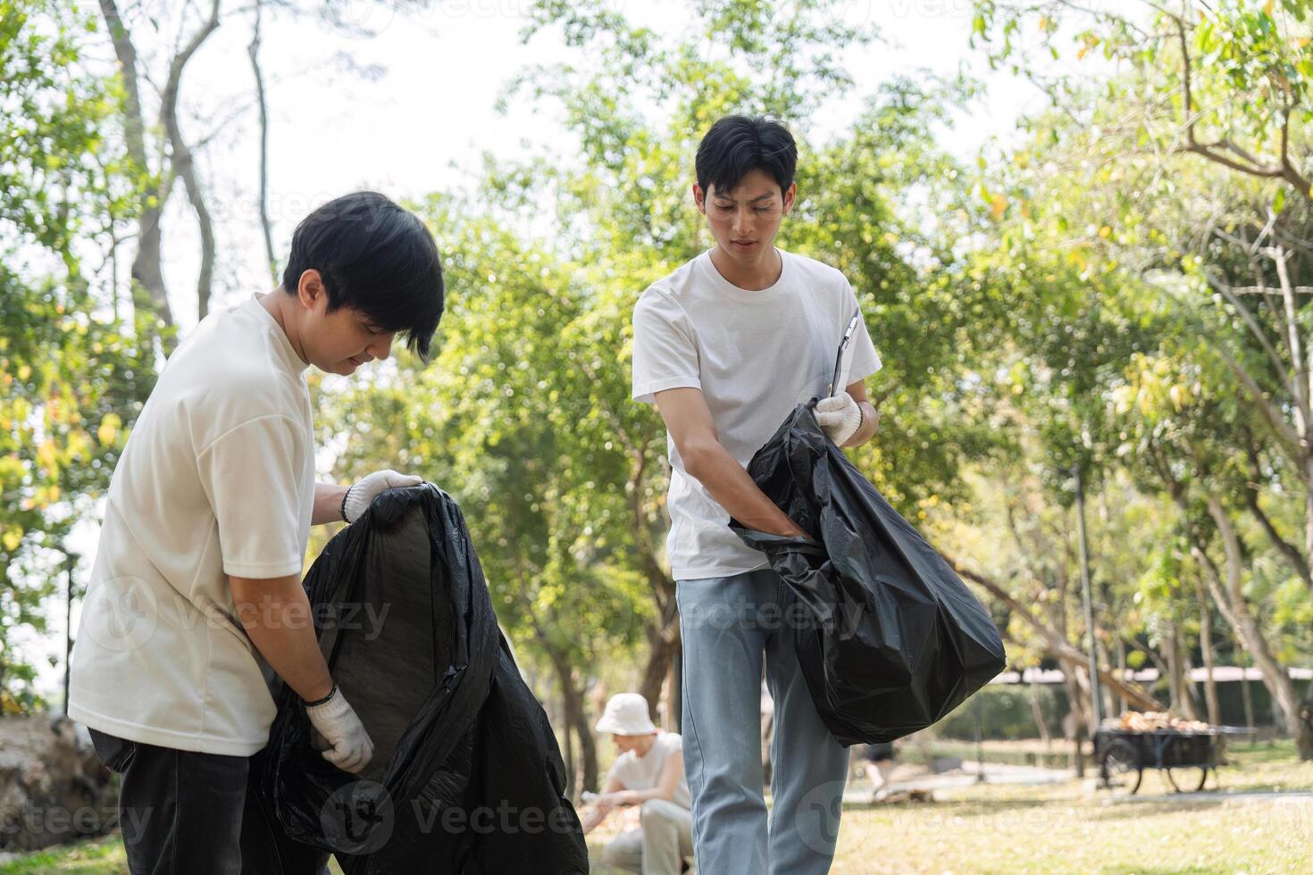 Volunteers cleaning up a park, promoting sustainability and environmental awareness. photo