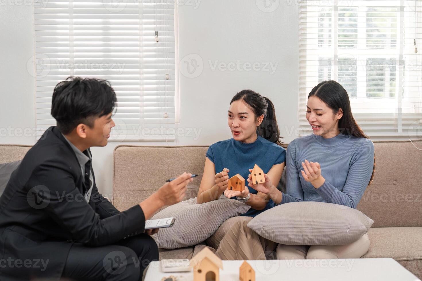 Real estate consultation. Clients discuss housing options with an agent showcasing enthusiasm and teamwork. photo
