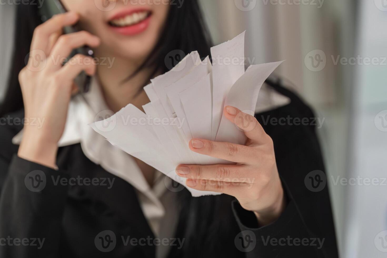 Effective communication in business. Woman on a phone call while managing tax documents. photo