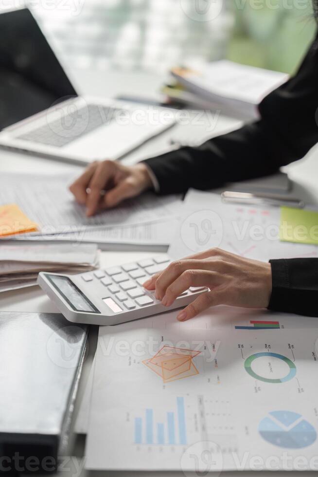 Business finance management. Professional accountant calculating taxes and analyzing financial reports at the office. photo