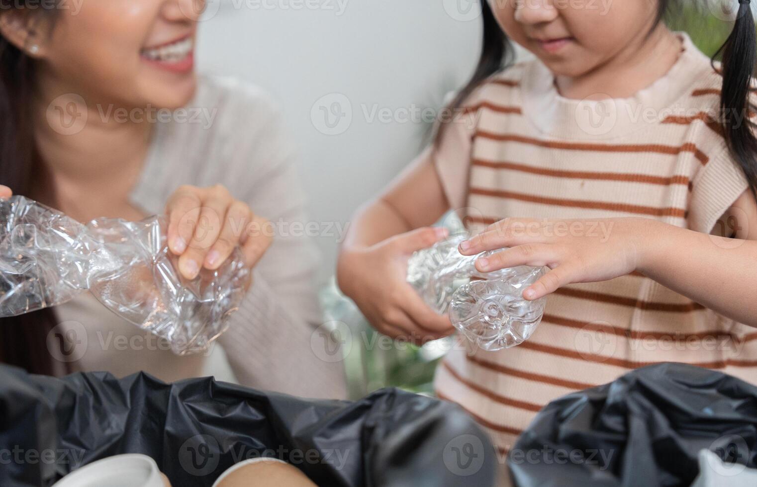Eco-Friendly Practices and Family Connection. A mother and daughter bond while sorting recyclables. photo