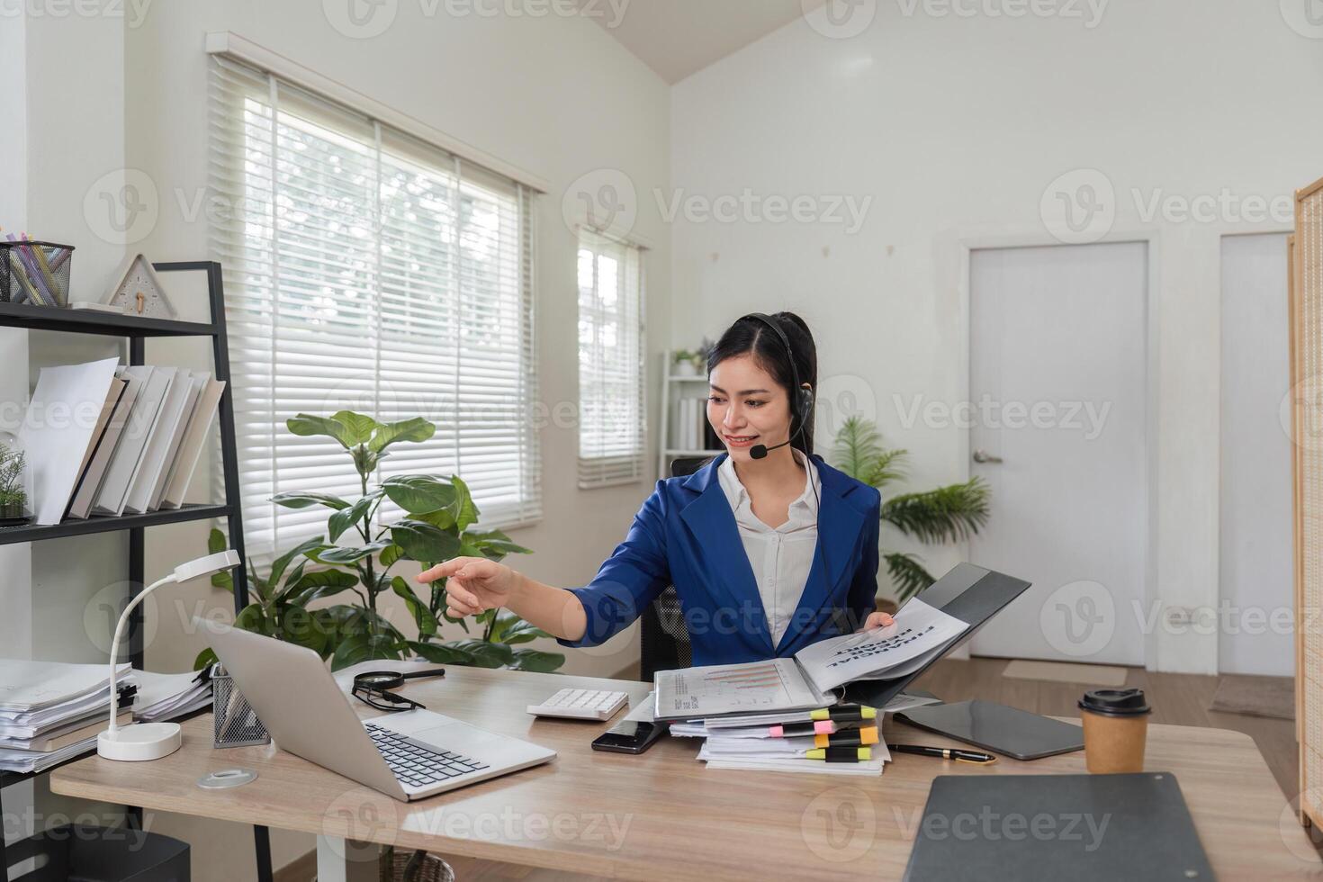 Remote work and communication. Woman on a call managing business tasks in a modern office. photo