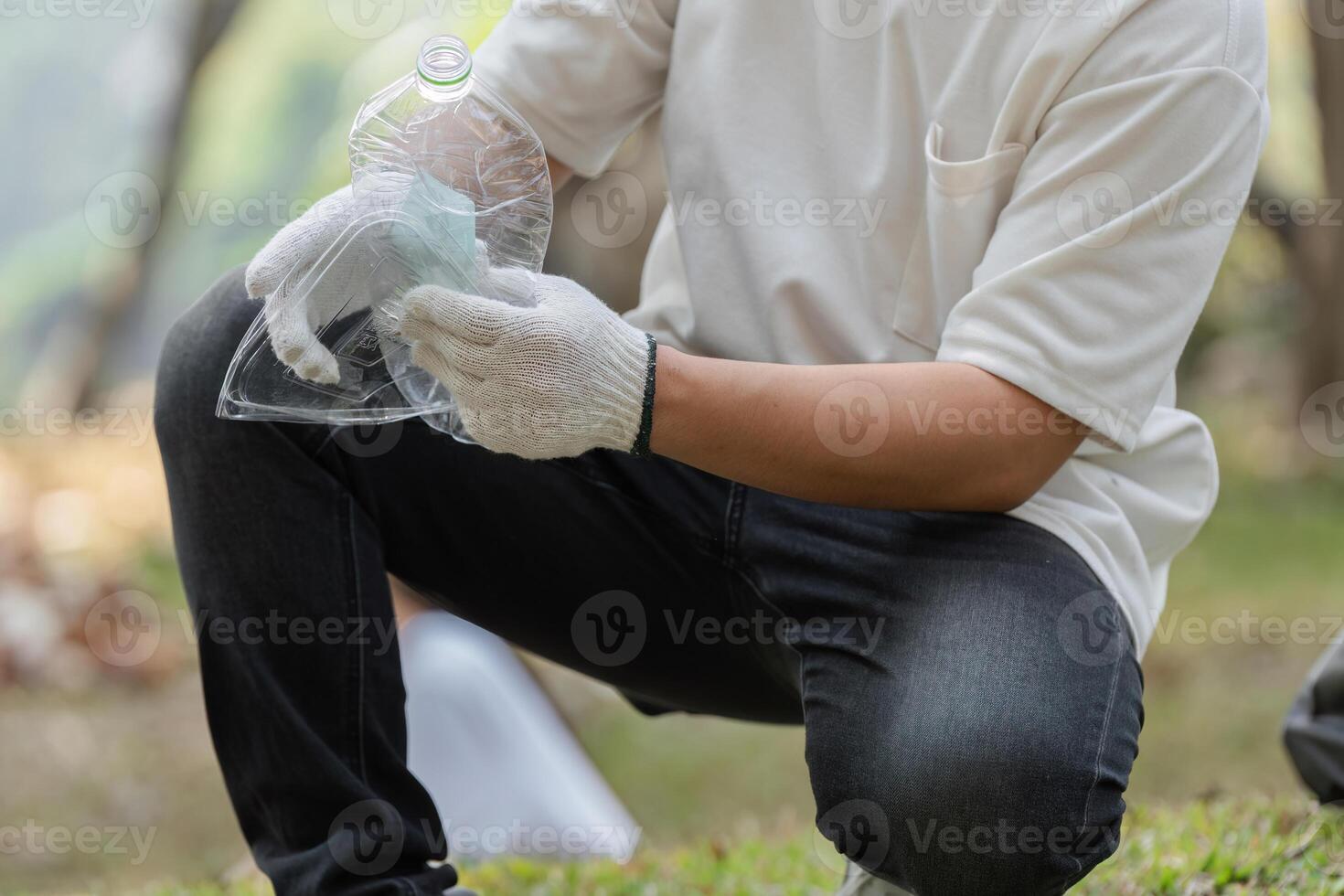 Focused Efforts. Volunteer sorting waste during a cleanup. photo