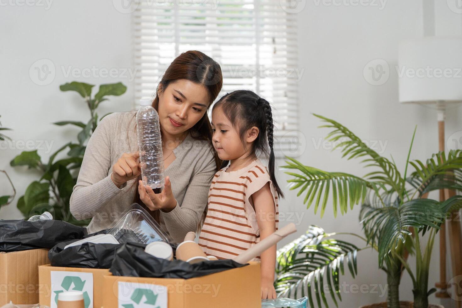 Recycling Awareness and Family Values. A mother and her child exploring the importance of recycling together with various plastic items. photo