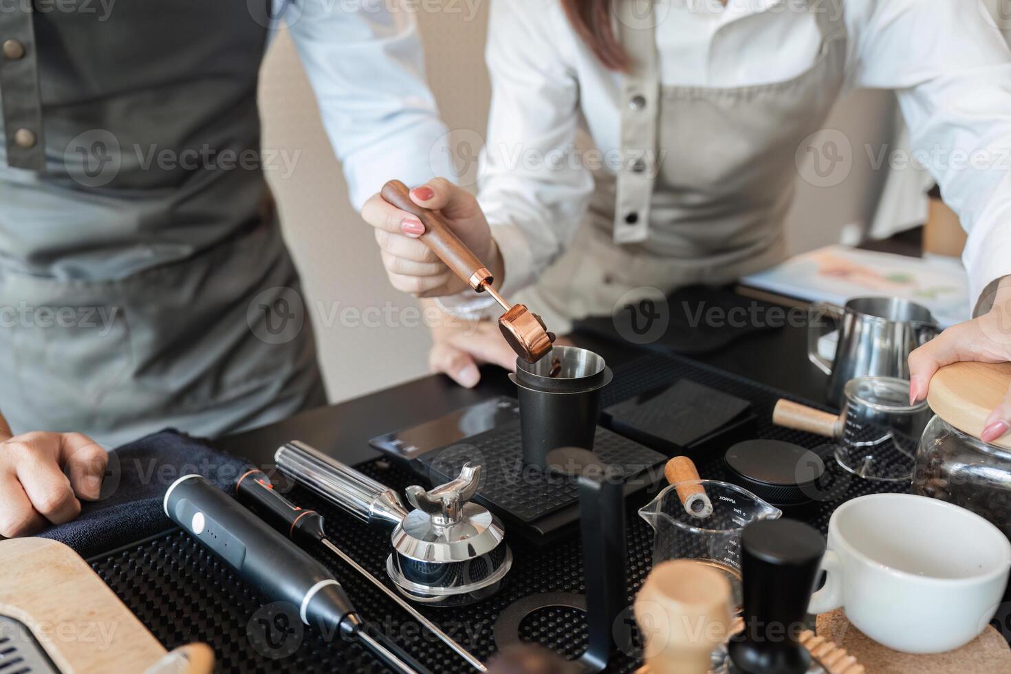 Coffee Brewing and Barista Techniques. Two baristas skillfully preparing coffee using specialty tools and techniques. photo