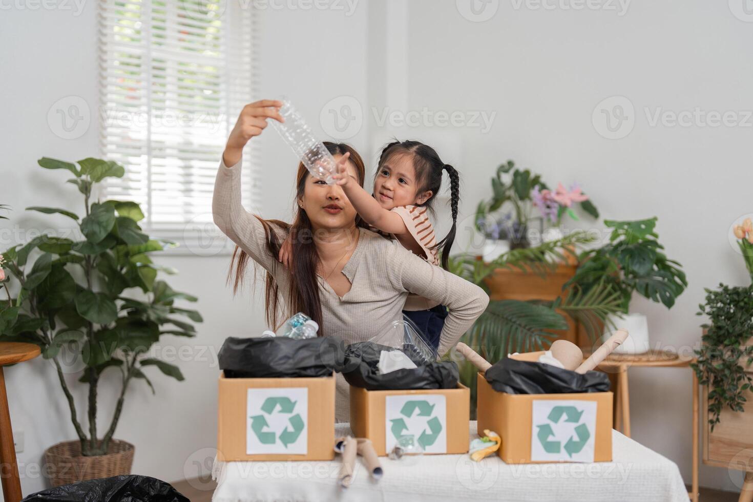 Recycling Education and Bonding Moments. A mother and daughter sharing a learning experience about recycling techniques. photo