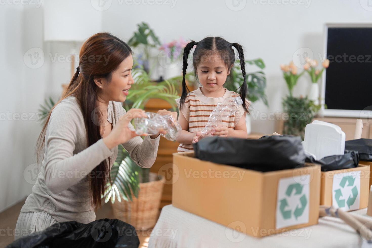 Eco-friendly Practices and Learning Together. A mother and daughter sorting recyclable materials in their living room. photo