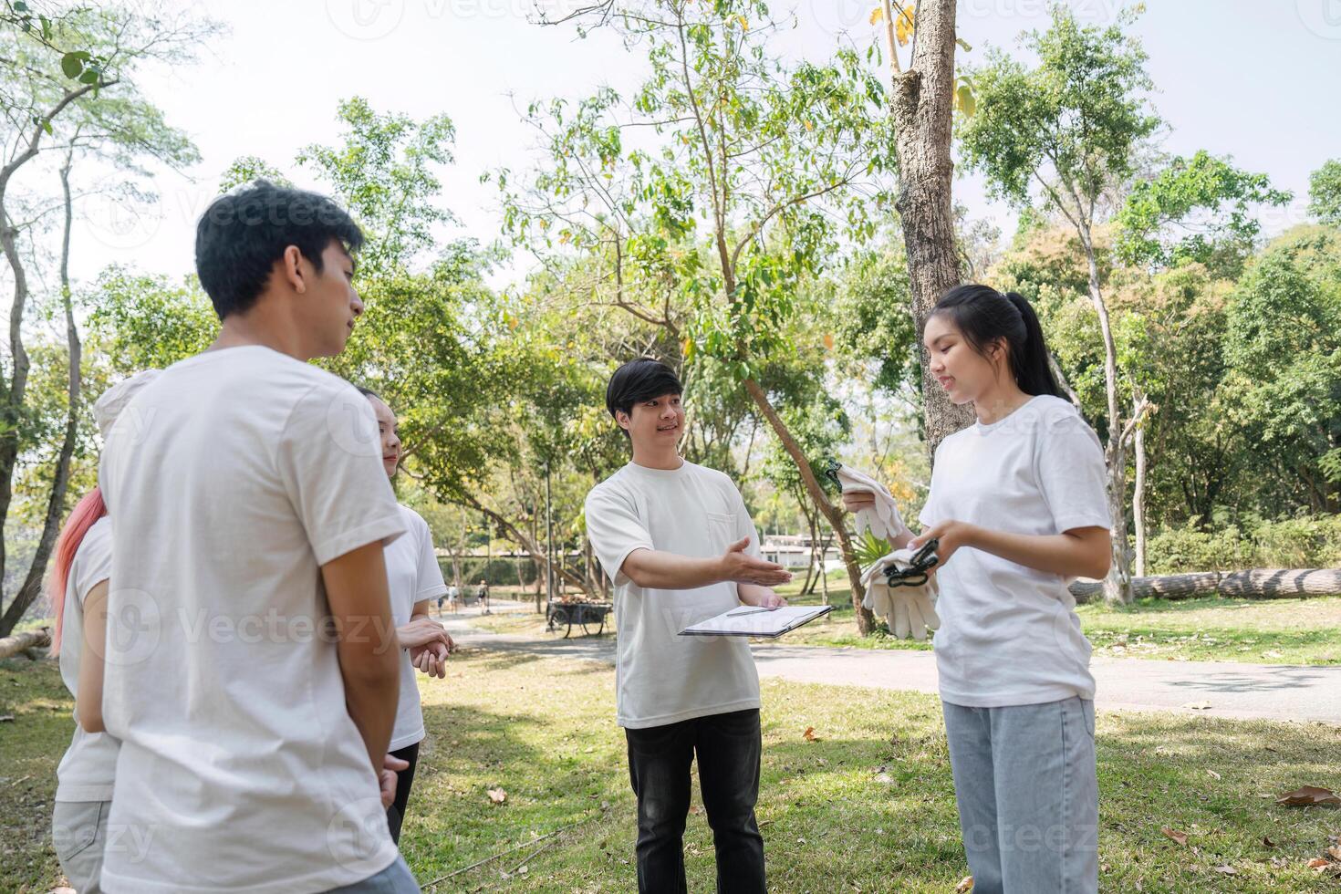 Community involvement. Volunteers discussing clean-up efforts in the park. photo