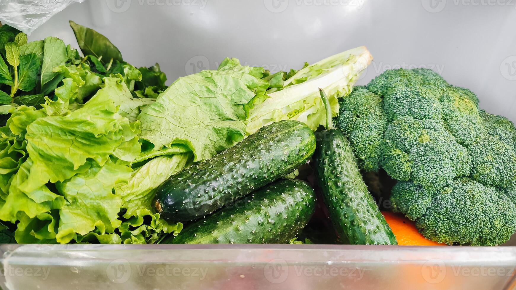 The vegetables are in the refrigerator drawer. Open the refrigerator. Healthy eating. photo
