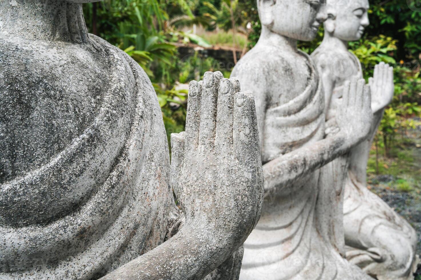 Close-up of the folded arms of the Buddha statue. The concept of Buddhism photo
