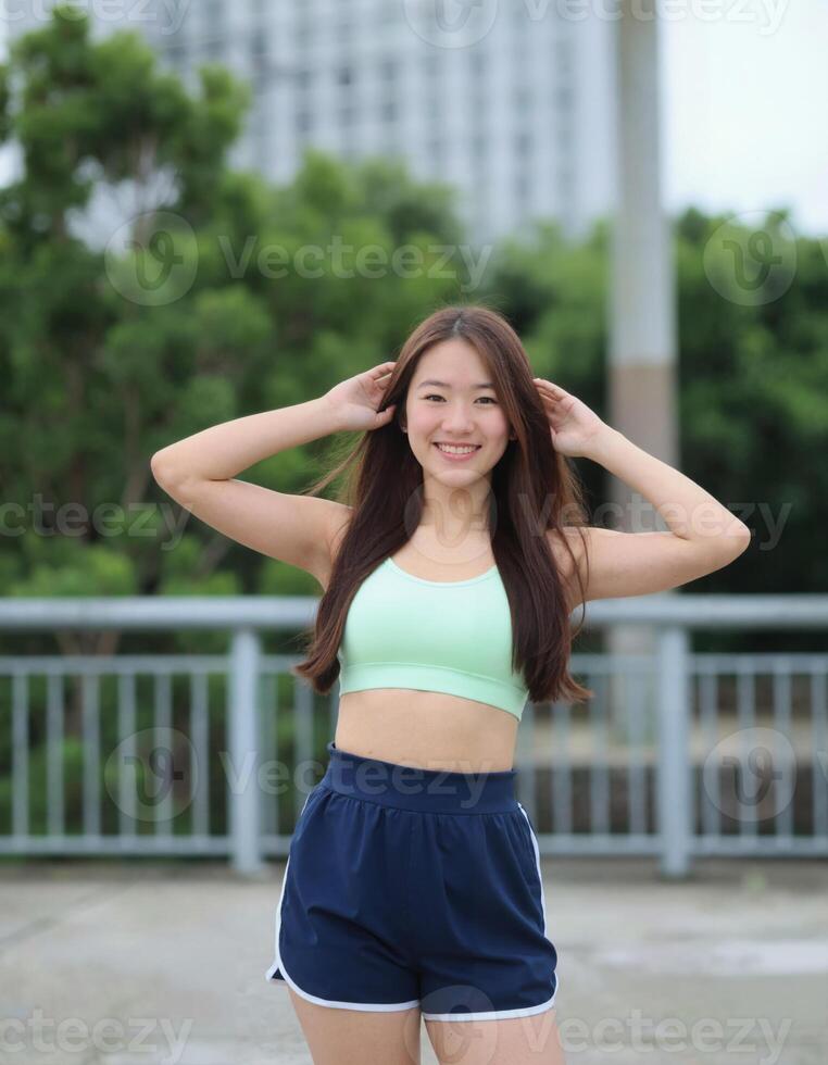 A young woman in a sports bra top and shorts photo