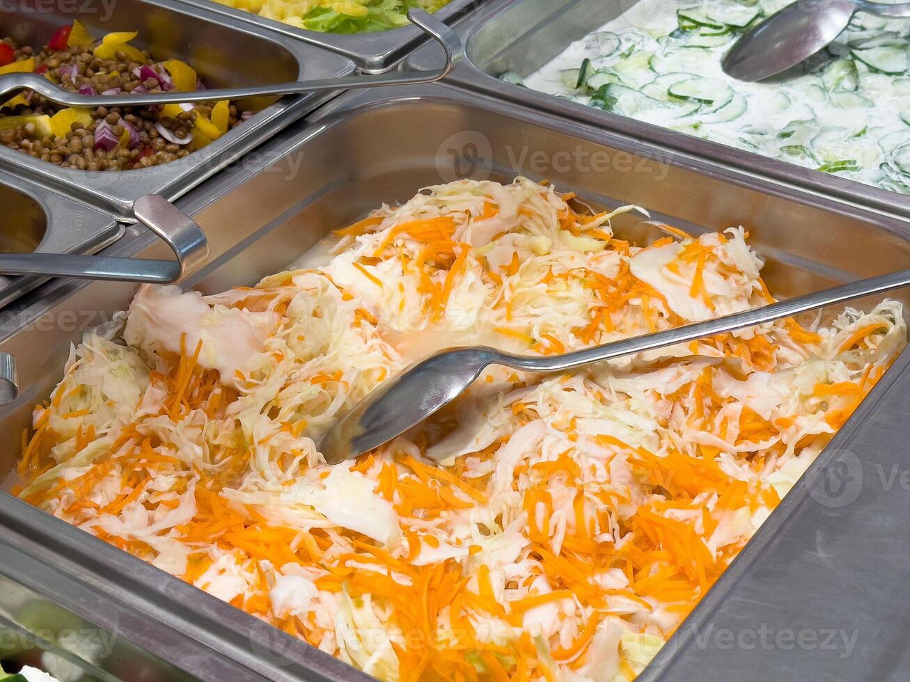 Fresh shredded carrot and cabbage salad in stainless steel buffet tray photo