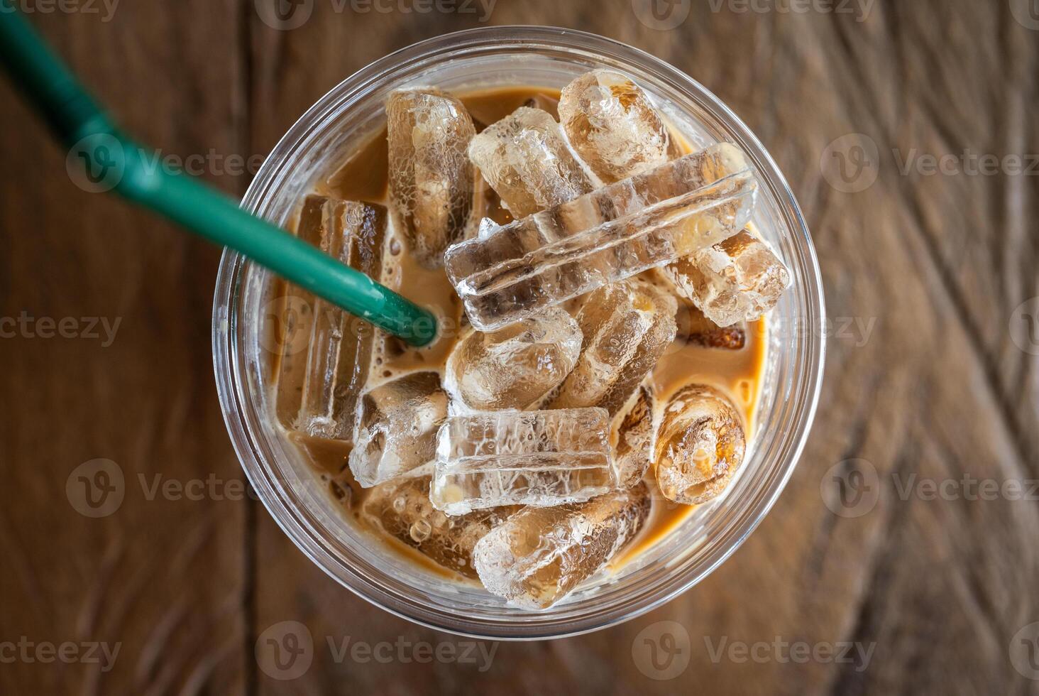 High angle view of a plastic cup of iced milk coffee. photo