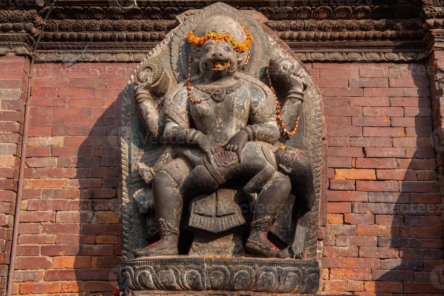 The stone sculpture of Hanuman is a Hindu god whose shape is half-monkey, half-human situated in Patan Durbaq square, Kathmandu, Nepal. photo