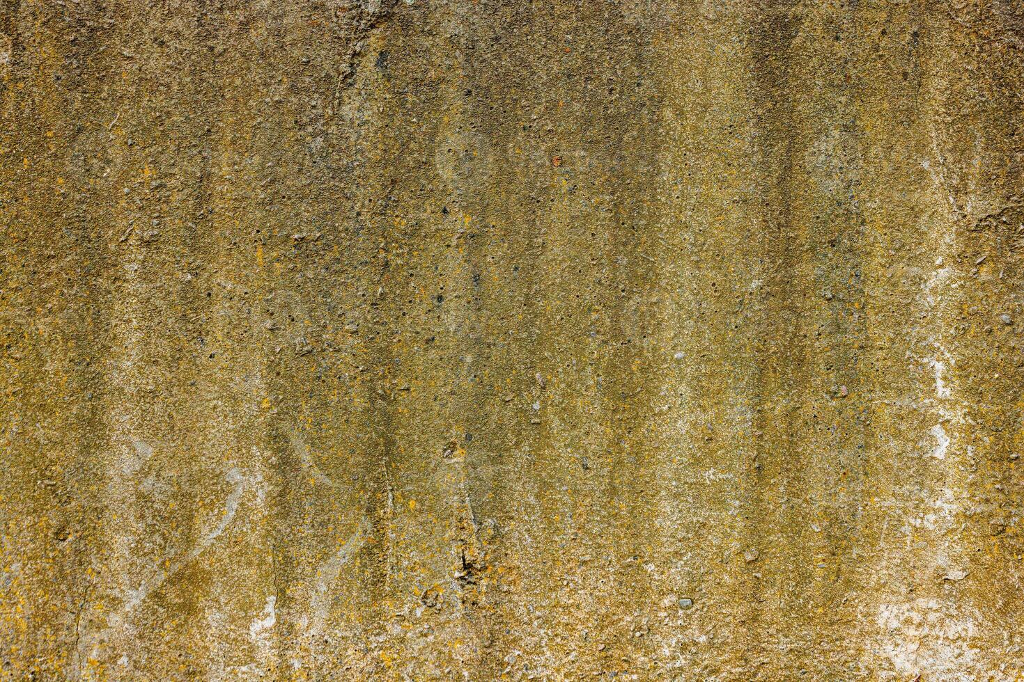 rough concrete wall with yellow stains photo
