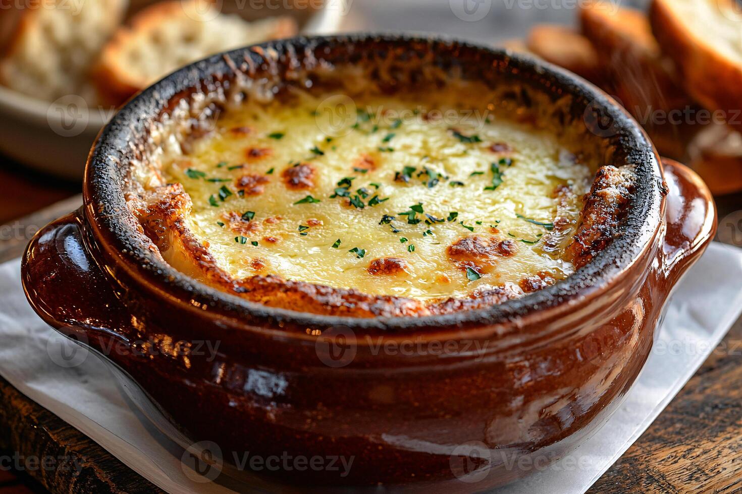French onion soup in a ceramic bowl, topped with melted Gruyere and crispy toast, offering rich, comforting flavors photo