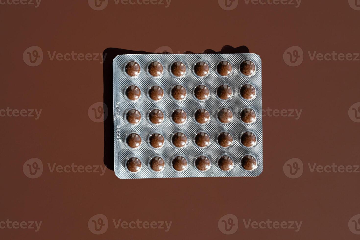 Pills Blister Pack On Brown Background. photo