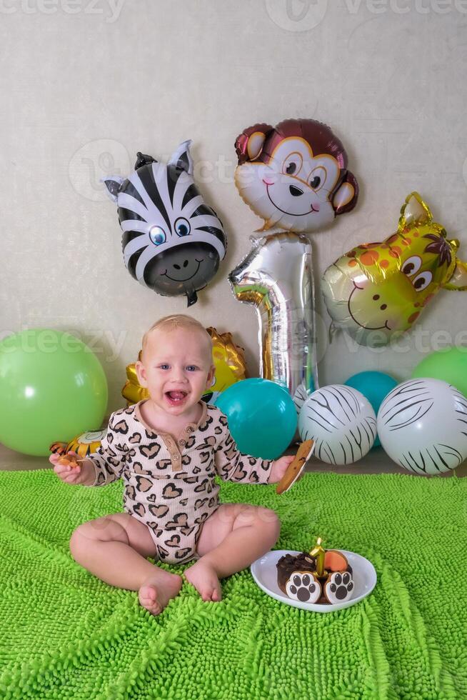 Child first birthday party with balloons in the form of African animals and a cake with a tiger photo