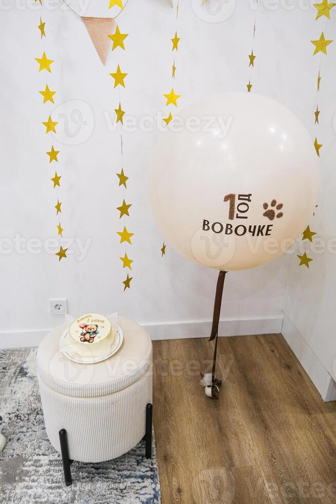 Baby first birthday party with cake and balloons photo