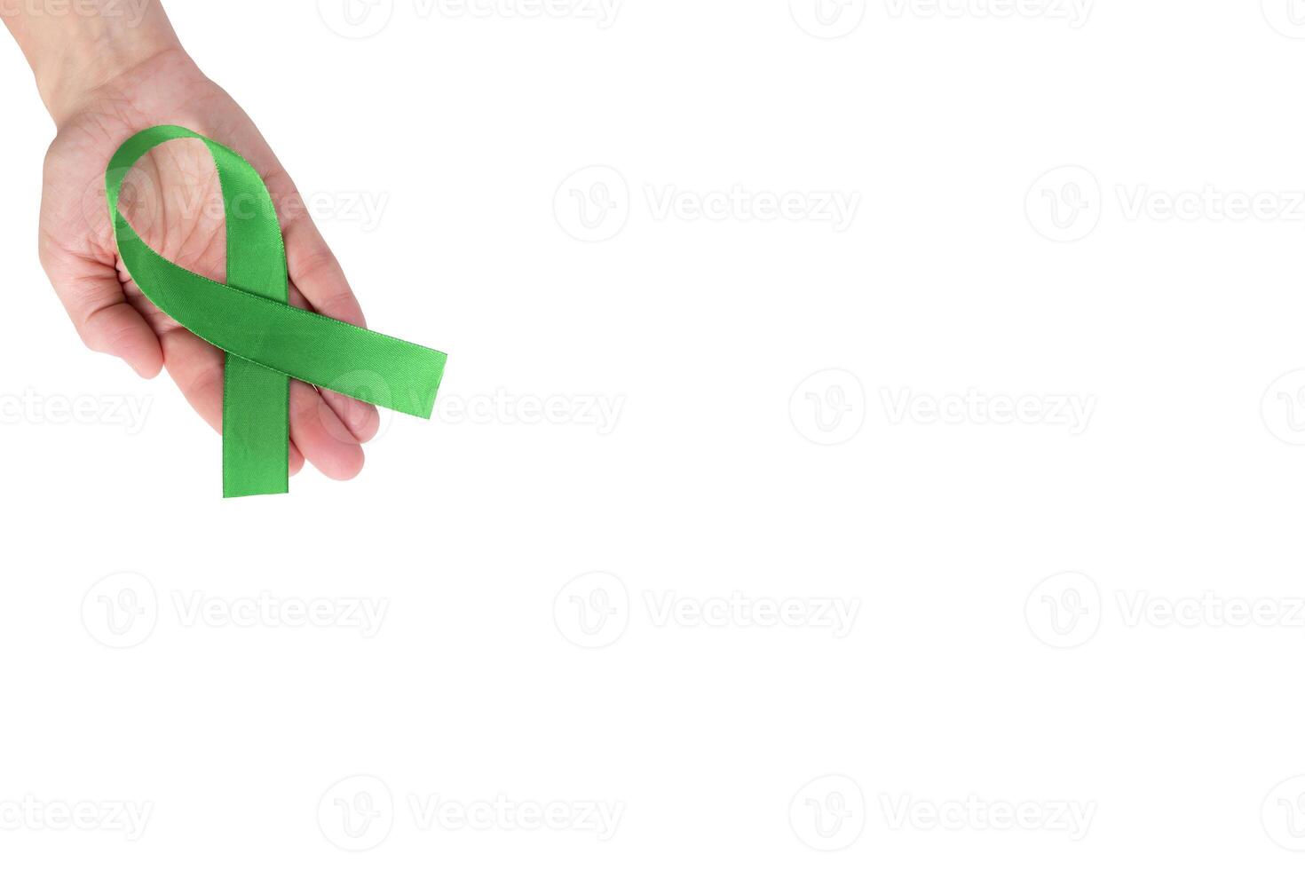 Green satin ribbon on the palm of a woman, isolated on a white background. Cancer awareness symbol. copy space photo